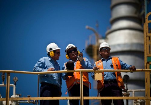 Construction workers looking ahead and talking at a construction site